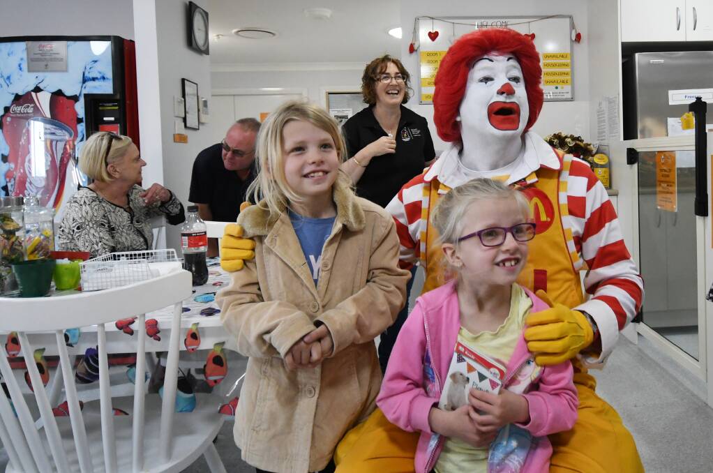 Big shoes, big hearts: Ronald McDonald has a laugh with Maddison and Carla Frazer at the tenth birthday celebrations on Saturday. Photo: Gareth Gardner