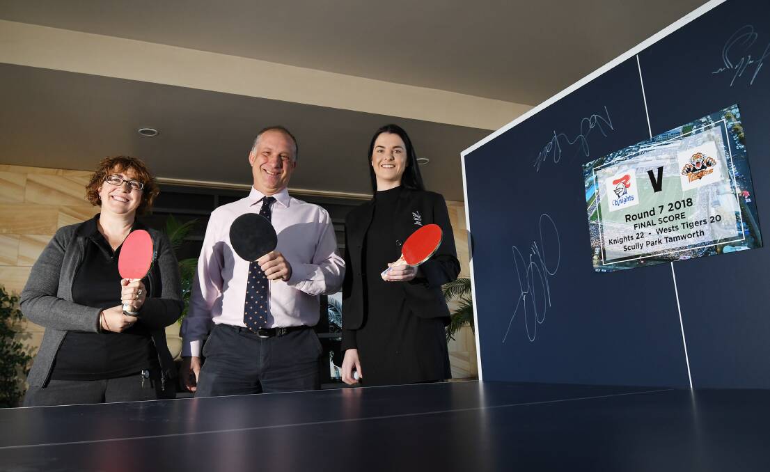 Ace: Ronald McDonald House's Debby Herdegen, with The Powerhouse's Ben Davies and Meredith Abrams alongside the signed table tennis table. Photo: Gareth Gardner