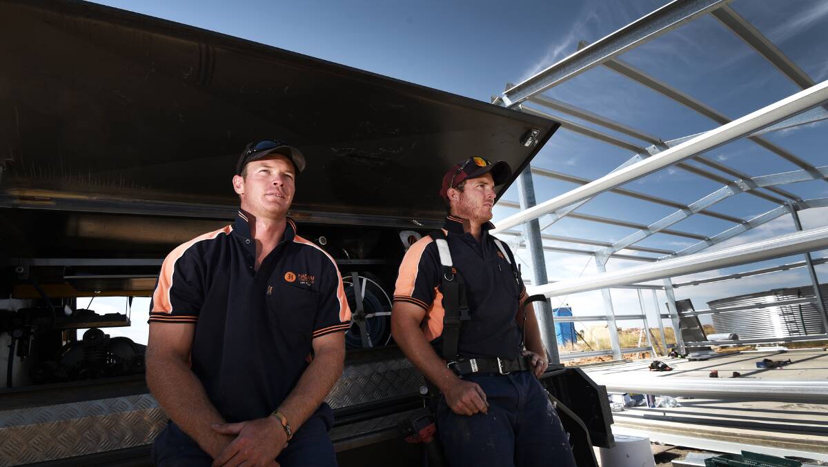 Not impressed: James Trappel and Luke Haslam are not happy after arriving at work to find almost $30,000 worth of tools had been stolen from a remote job site. Photo: Gareth Gardner 160217GGA01