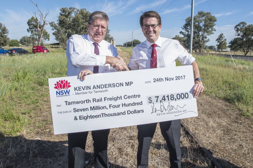 Freight city: Mayor Col Murray and Kevin Anderson accept the cheque at the Goddard ln Wallamore rd site of the proposed intermodal rail freight hub. Photo: Peter Hardin