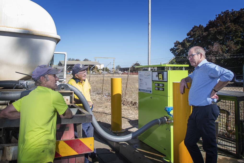 Water you think: Council's water director Bruce Logan talks with some regular water filling station users after installing the new automated system on Lockheed Street. Photo: Peter Hardin