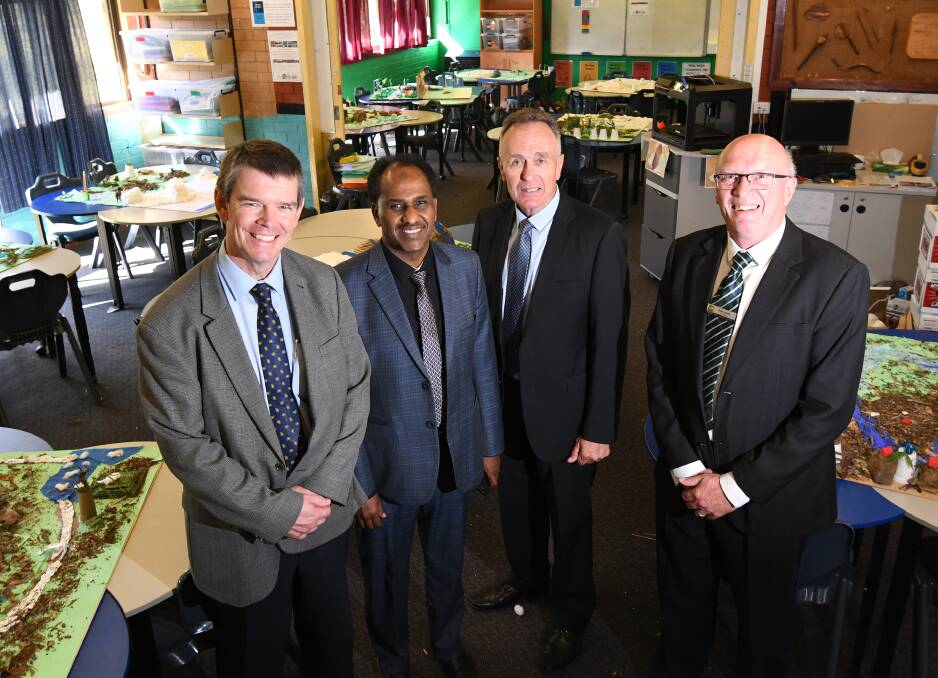 Back to learning: Department of Education Directors Mark Grant, Ahmed Deria and Frank Potter were impressed by Peel High's innovative Schools of The Future program, which was installed by principal Rod Jones. Photo: Gareth Gardner