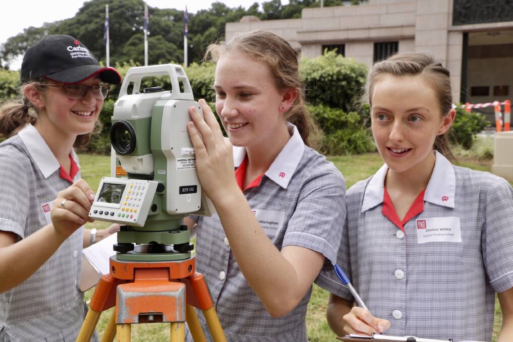 Measured approach: Carinya students Felicity Roach, Ella Fotheringham and Chelsea Willey at the Women in Surveying event at Sydney's Hyde Park for International Women's day. Photo: Supplied