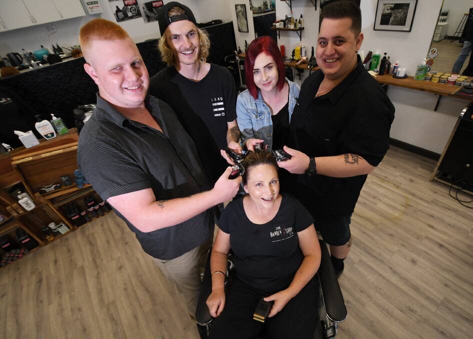 Close shaves: Vincent Fritze, Reece Bailey, Montana Pulford and Christian Fritze give teacher Kylie Potts a lesson after graduating from the 2340 Barber Shop. Photo: Gareth Gardner 260319GGA02