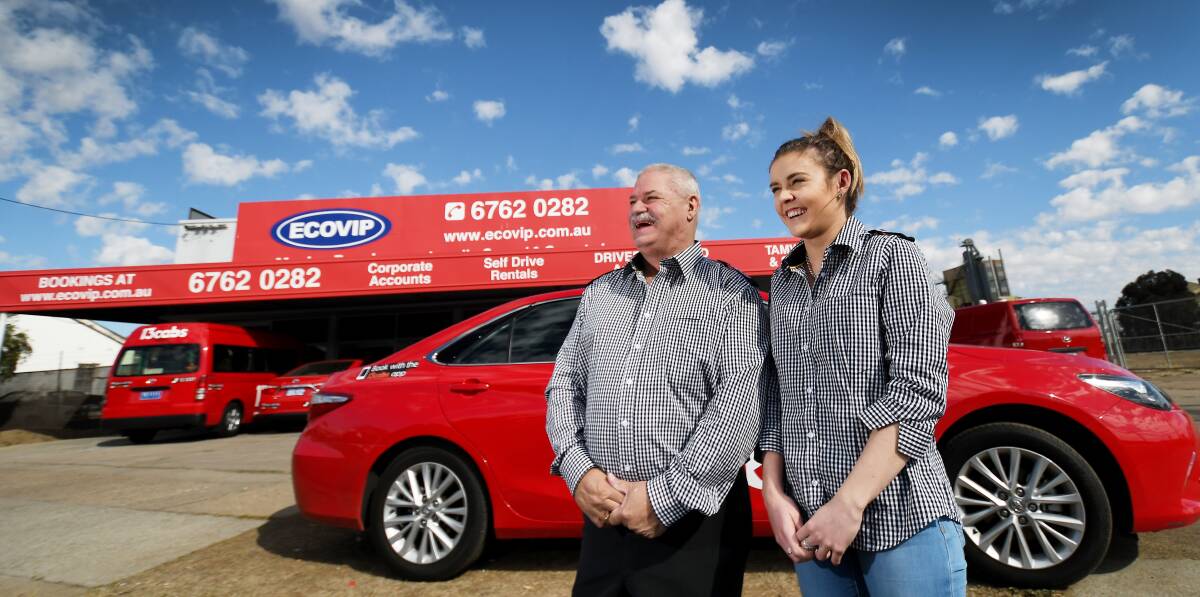 Red and ready: Eco VIP owner Chris Doulis and office manager Claudia Turner are looking to take on 16 more staff after taking on the 13cabs banner. Photo: Gareth Gardner