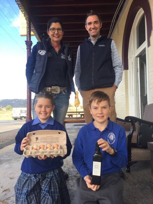 Serving it up: Currabubula Pub owner Kathy Smith, school principal and olive oil producer James Steel, and students Nigella Bonner and Hamish Filby. Photo: Chris Bath