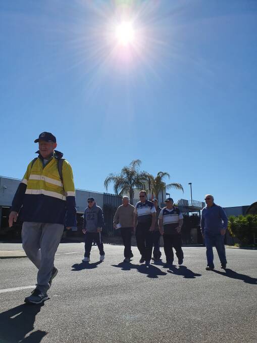 Walking on sunshine: Mike Cashman leads a group of supporters out of Wests Leagues Club on his 12 day 296 km walk to Newcastle on Tuesday. Photo: Chris Bath