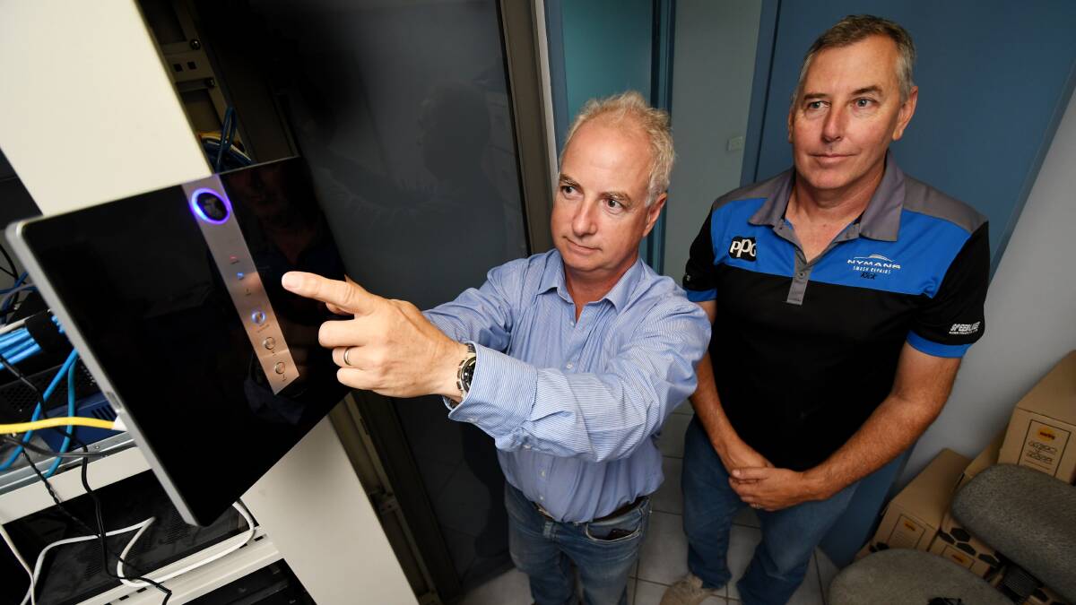 Waiting game: IT consultant Paul Adnett and Nyman's Smash Repair's Rick Vines have been on hold with Telstra for over 14 months. Photo: Gareth Gardner
