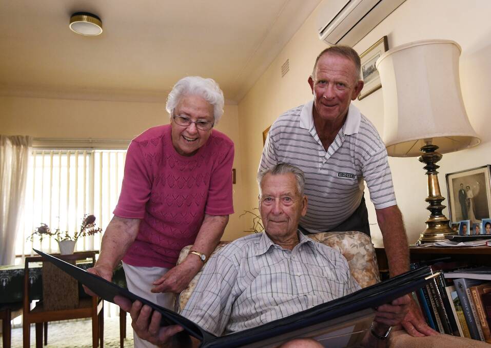 Century of memories: Long time friend Betty Urquhart, son David McDonald and soon-to-be 102 year old Nevell McDonald go through a photo album as they celebrate the 100th birthday of Nevell's sister Phyllis Peterson. Photo: Gareth Gardner