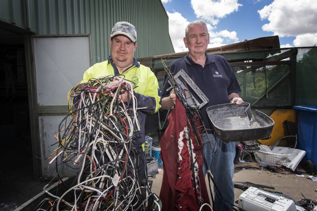 Think then throw: Challenge forklift operator Roly Caterer and CEO Barry Murphy show a few items of contamination found in household recycling bins. Photo: Peter Hardin