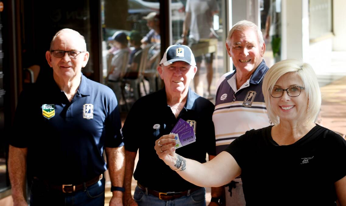 Chipping in: Men of League members Ken Thompson, Kevin Robinson and Ron Surtees deliver $500 of food vouchers to Lisa Thomas. Photo: Gareth Gardner