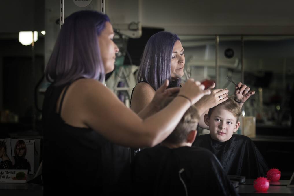 Sensitive snip: Illegal Lengths operator Babs Sharp is offering sensory-friendly haircuts for people living with autism and sensory processing disorders like Phoenix Morrow. Photo: Peter Hardin
