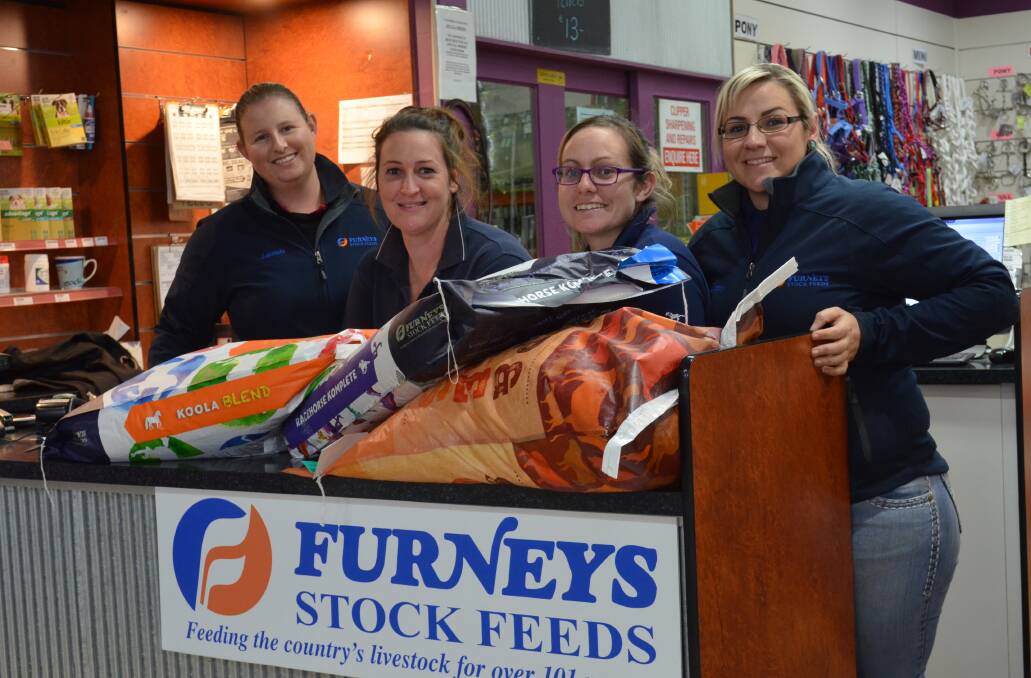 Good and bad: While business is booming at Furneys Stock Feeds manager Lucinda Hellyer and sale staff Tiffany Rees, Lasche Perett and Brittany Burge are feeling the mental strain of drought through their customers. Photo: Chris Bath