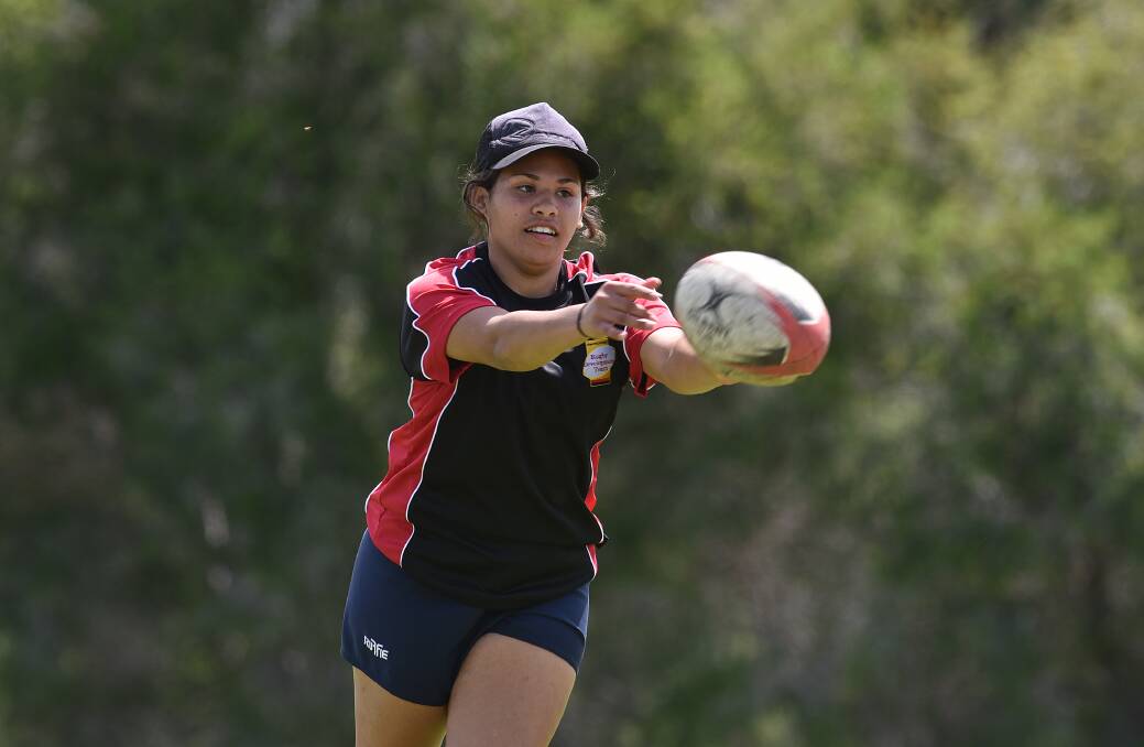 Orange sevens star Courtney Currie throws a pass during a training session at Farrer. Photo: Gareth Gardner 071016GGE01