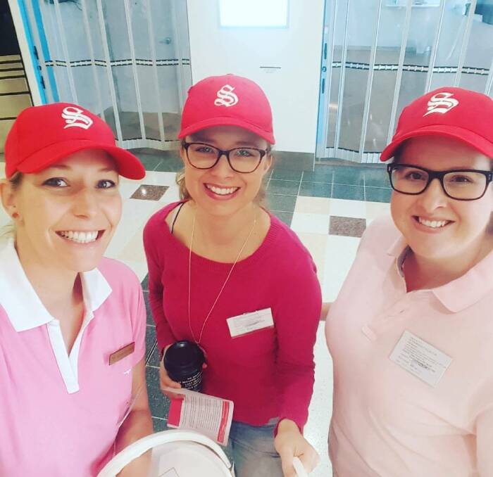 Radiation raisers: Cancer Centre radiation therapists Deanna Chapman and Katelyn Williams flank radiation physicist Sally McKinnon during Serendipity's Red Bucket day.