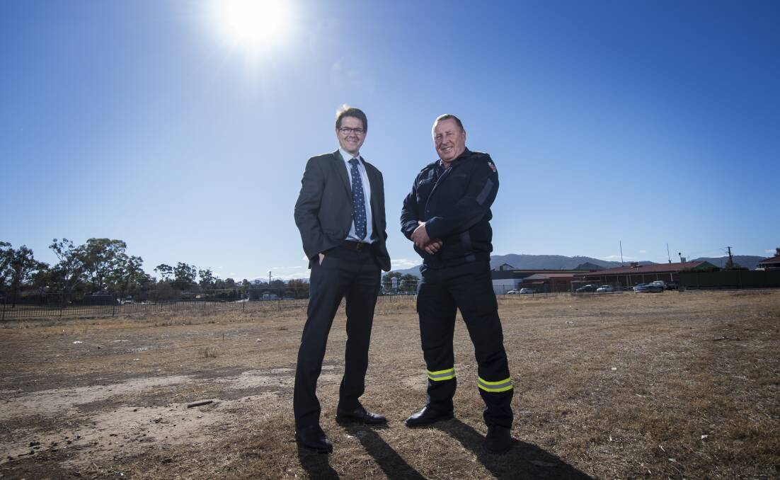 Land acquired: Kevin Anderson and Zone Commander Tom Cooper stand on the Ringers Road parcel of land that will soon be the home of a new $5 million fire station.