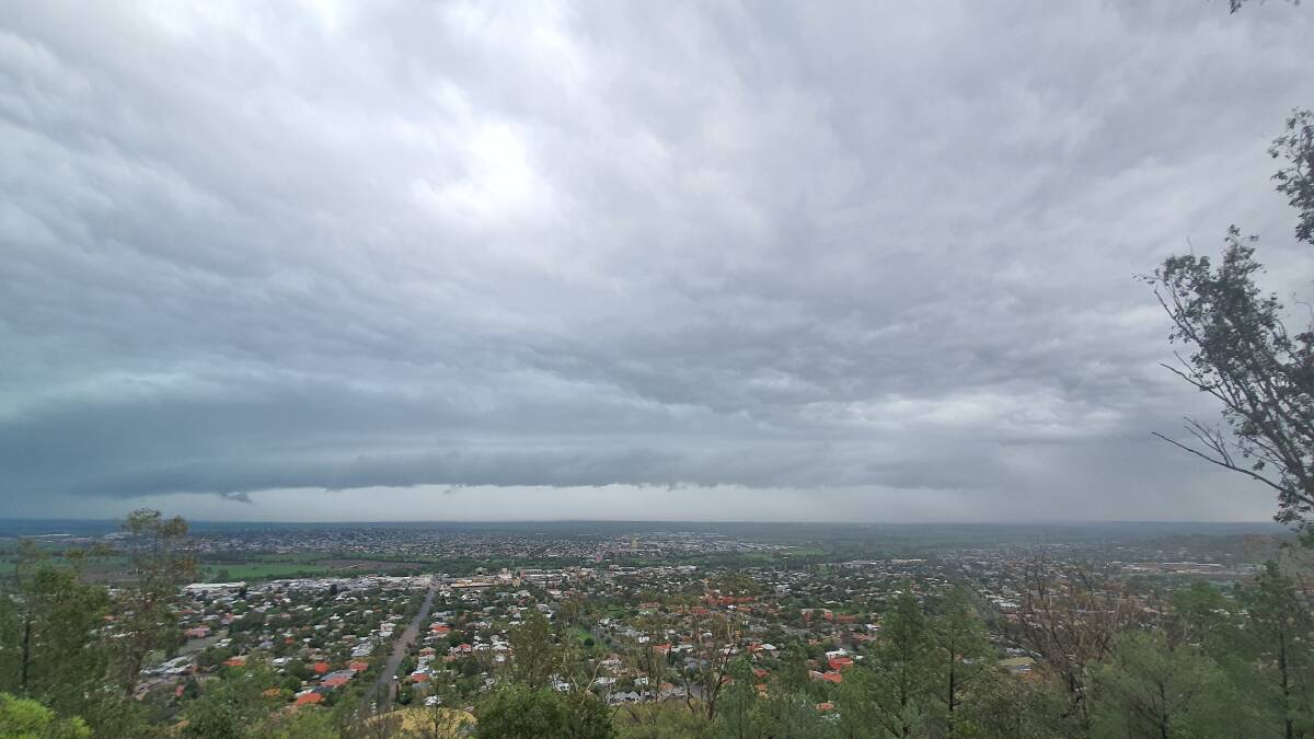 IT'S COMING: A look from Oxley Lookout just before the skies really opened up in town. Photo: Ben Jafrey