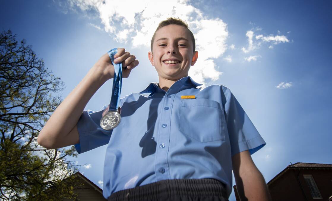 MEDALS: Tamworth Public School student Adam Williams with his medals from the NSW PSSA Athletics Championship. Photo: Peter Hardin