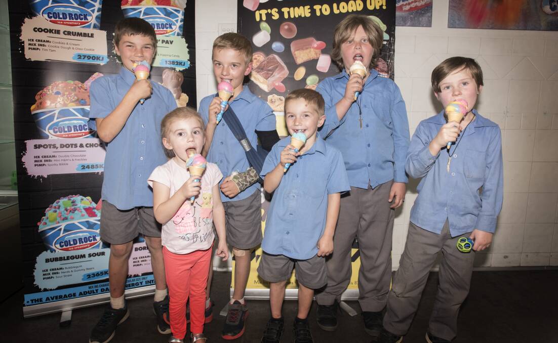 WEATHER FOR IT: Riley, Lily, Jacob and Travis Foye and William and Harrison Pepper enjoy an ice cream. Photo: Peter Hardin