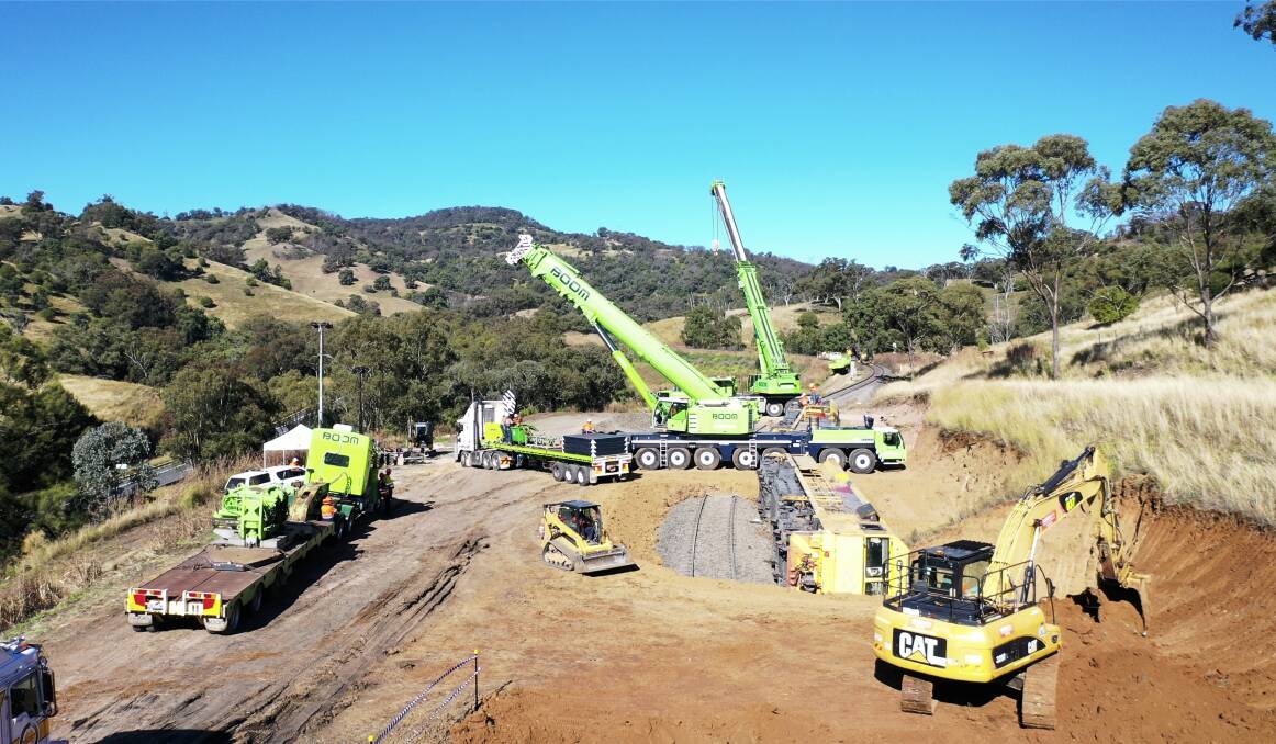 Cranes on the ground at the derailment site. Photo: Supplied