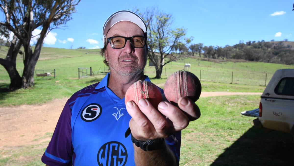 John Trickett with the first ball used in the first match of Peel Valley Bush Cricket 12 years ago and another ball they found at Dungowan when slashing the field to get ready to play on.