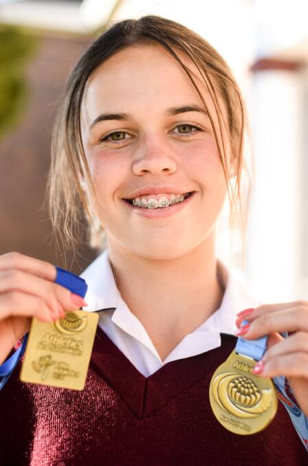 BACK ON THE TRACK: Lacie Quigley shows off some of her latest medals she has won. Photo: Quirindi High School