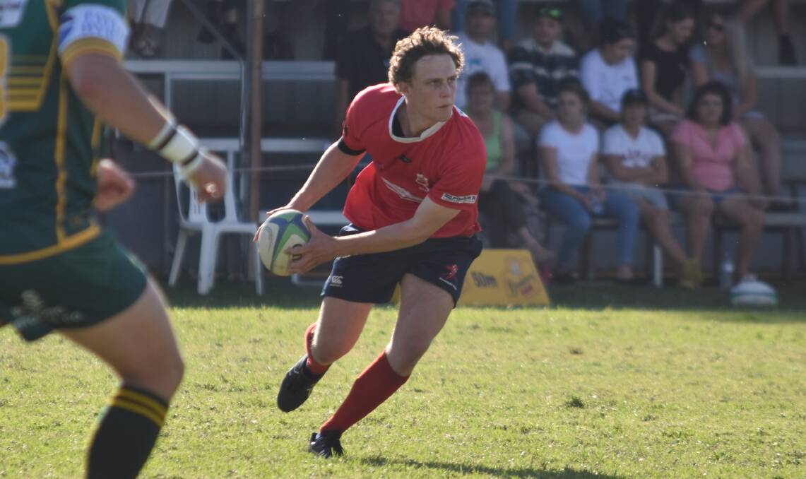 LONG BALL: Joe Hinchey looks to send the ball wide for the Red Devils against Inverell last weekend. Photo: Ben Jaffrey