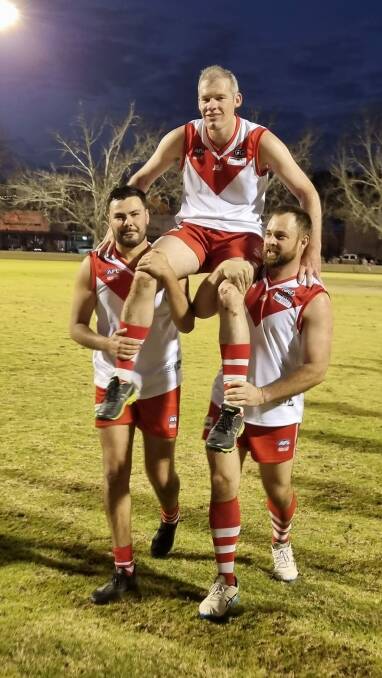 CENTURY: Stephen Fairless is chaired off the field after his 100th game by Jayden Taylor and Kim Farrell. Photo: Supplied