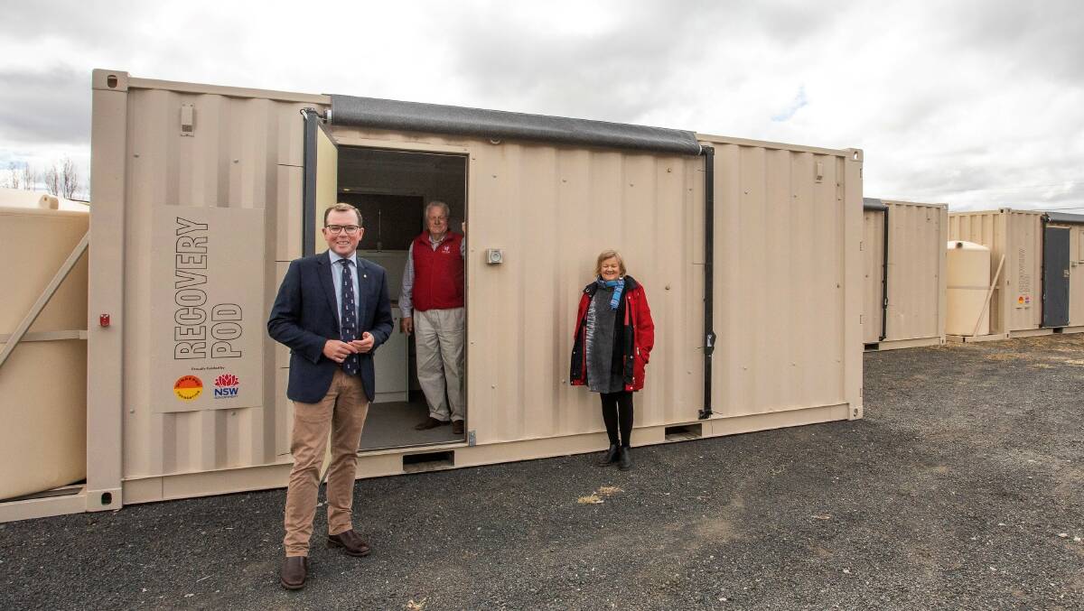 Northern Tablelands MP Adam Marshall, Weir Built Cranes Business Manager Peter Teschner and Glen Innes Severn Council Mayor Carol Sparks inspect the new bushfire recovery pods on Tuesday.