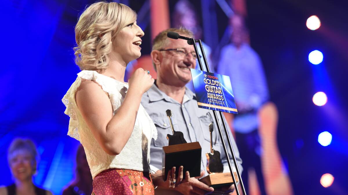 FAMILY EFFORT: Ashleigh and Brett Dallas accept the Golden Guitars for Traditional Country Music Album of the Year. Pictures: PETER HARDIN