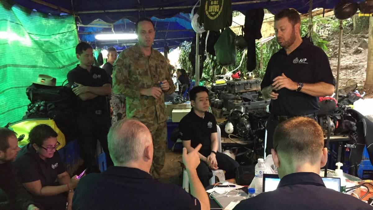 POSTED: Major Rubin translates orders from the Thai rescue commander during a Team Australia brief.