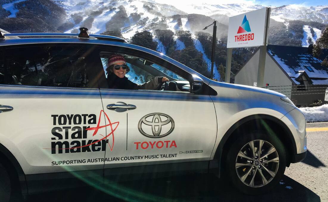 ON THE ROAD: 2016 Star Maker winner Karin Page in her Toyota vehicle at Thredbo this year where she played at the Snowy Mountains Country Music Festival.