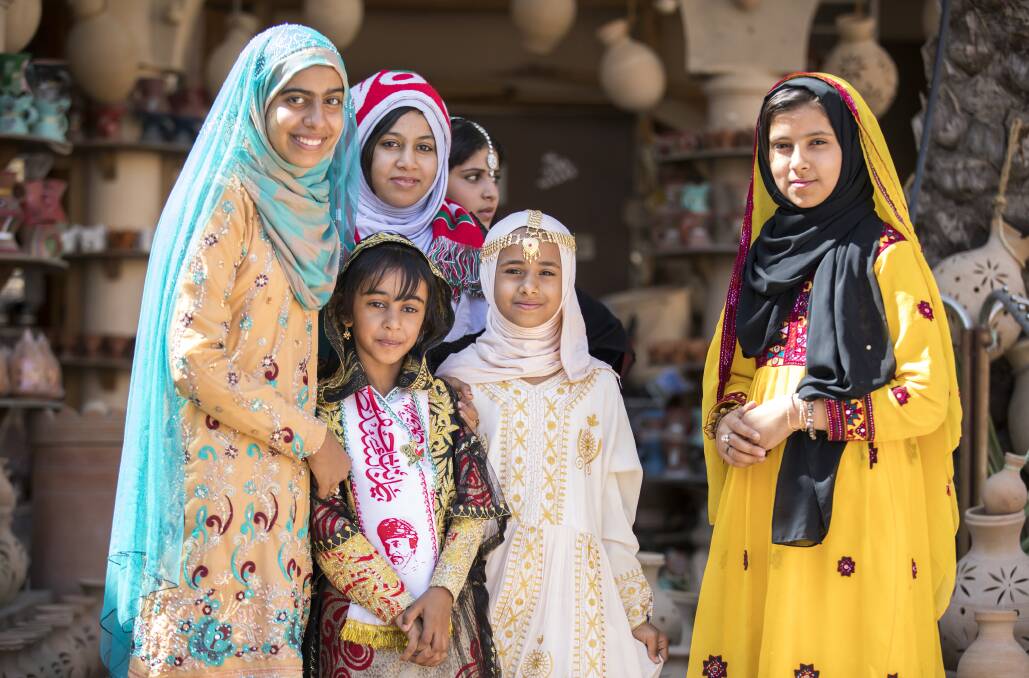 BEAUTIFUL: Omani girls dressed in traditional clothing at a souk.