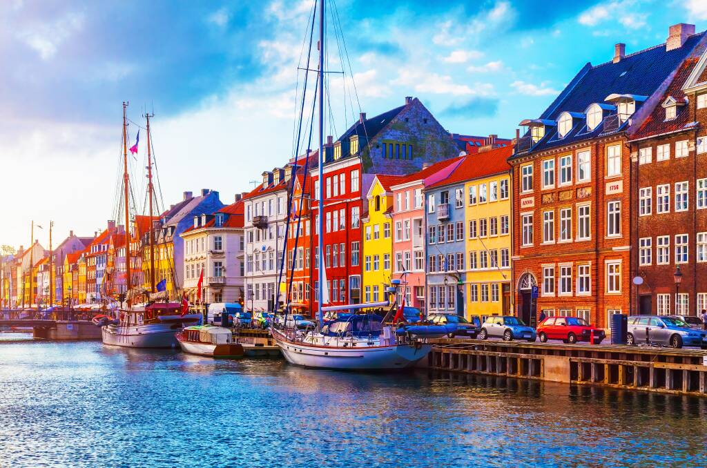 COLOURED WORLD: Sunset at Nyhavn pier in Copenhagen's Old Town. While in Copenhagen you will also be enchanted by the Little Mermaid statue by Edvard Eriksen.