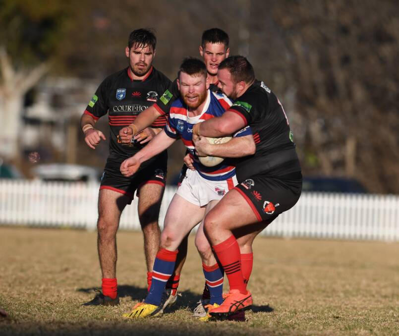 BEAR TRAP: Lavis is manhandled by Ben Jarvis at Jack Woolaston Oval this month. Photo: Mark Bode