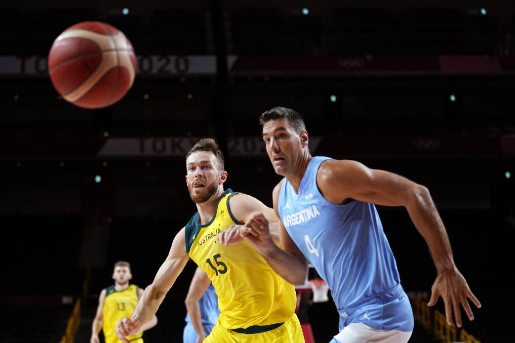 AUSSIE PRIDE: Nick Kay and Argentina's Luis Scola in action during the Boomers' quarter-final win. Photo: Charlie Neibergall/AP