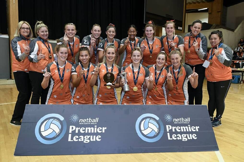 NO 1: Eliza Perkins (back row fifth from left) and her Fury teammates experience that grand final-winning high. Photo: Netball NSW