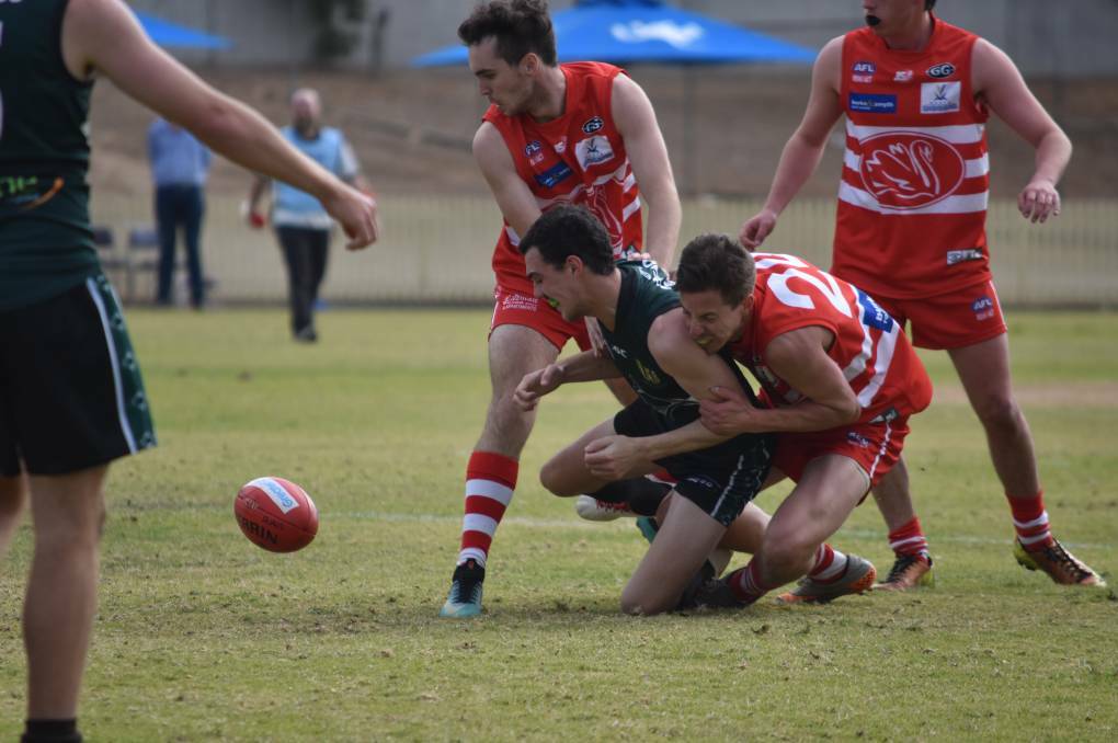 HEAVY HITTER: Andrew Finlay delivers a strong tackle for the Swans in Saturday's loss to New England at No.1 Oval. Photo: Ben Jaffrey