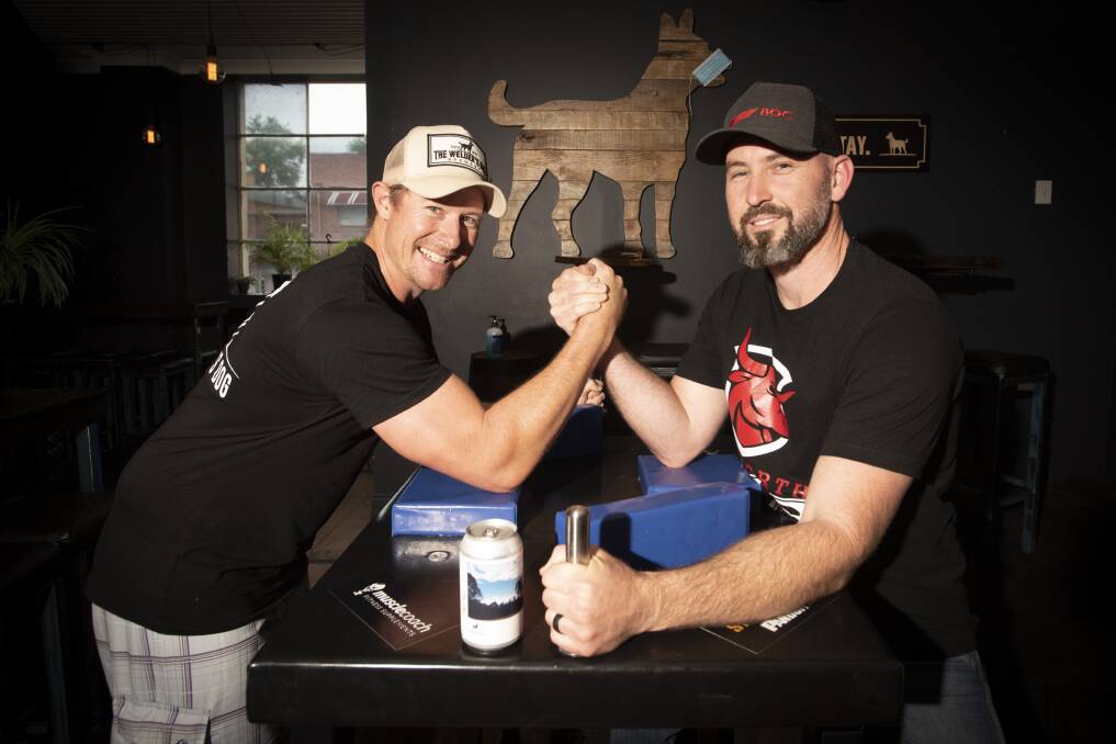 POWER GAME: Ben Coombes, of The Welder's Dog, and Rod Brown, founder of Tamworth Bulls Armwrestling, at the Welder's Dog Tamworth. Photo: Peter Hardin