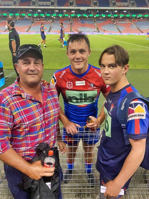 FOR POSTERITY: Mitch Henderson (centre) meets with his father, Peter, and younger brother, Charlie, after the Knights-Bulldogs trial at Newcastle on Monday night. Photo: Suppled