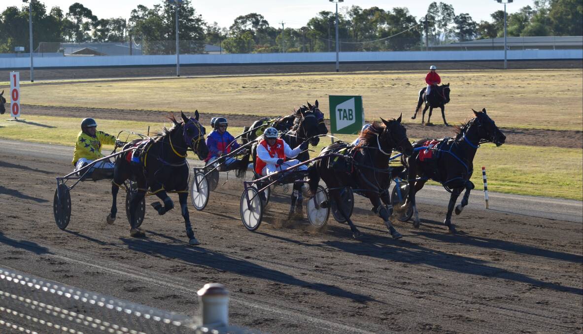 WINNING COMBINATION: Bevan Pringle pilots Rory Mclory (outside) to victory at Tamworth Paceway. Photo: Ben Jaffrey.
