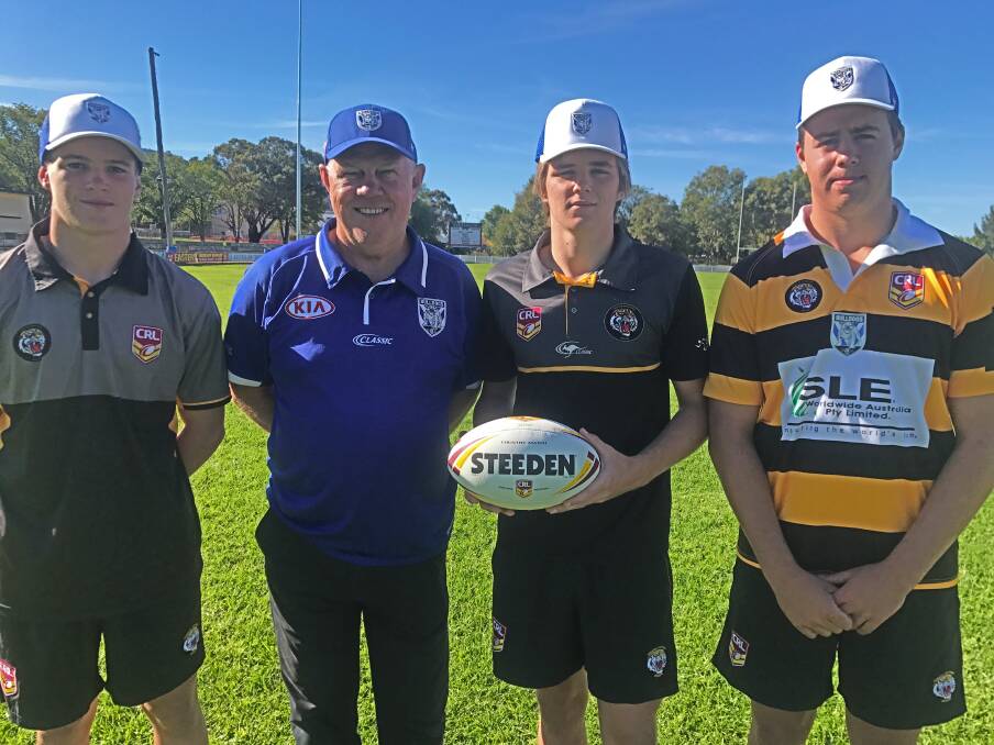 PATHWAY: The Bulldogs' recruitment co-ordinator, ex-NRL star Mark Hughes, with young Tigers (L-R) Kobe Bone, Daniel Kelly and Jack Todd. Photo: Supplied