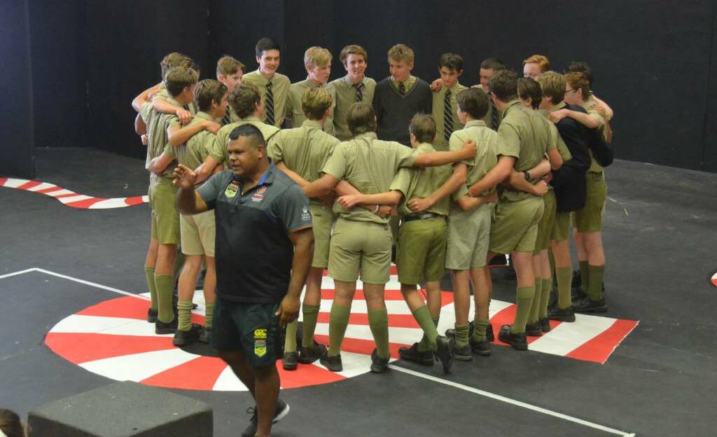 WORTHY: Former NRL star Dean Widders instructs students from Croft House at The Armidale School on how to perform the war cry dance. 