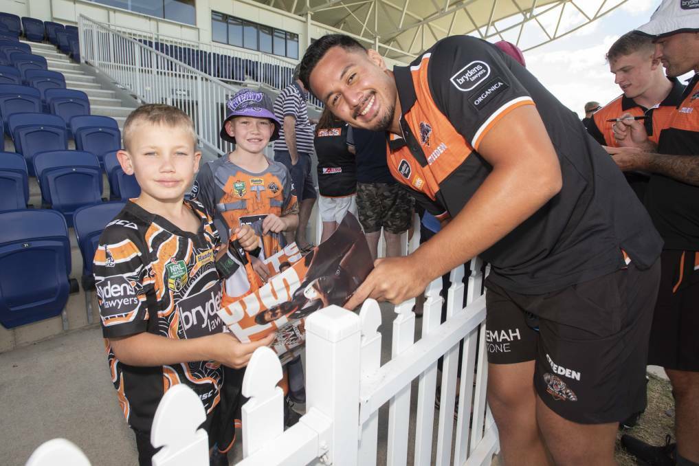 STAR SIGHTING: Tyler and Parker O'Neile get up close with Wests Tiger player Kelma Tuilagi at Scully Park this week. Photo: Peter Hardin