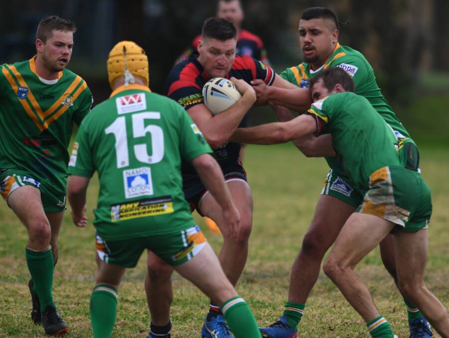 RAMROD: Roosters prop Jacko Brookman looks to blast a hole in the Roos' defence. 