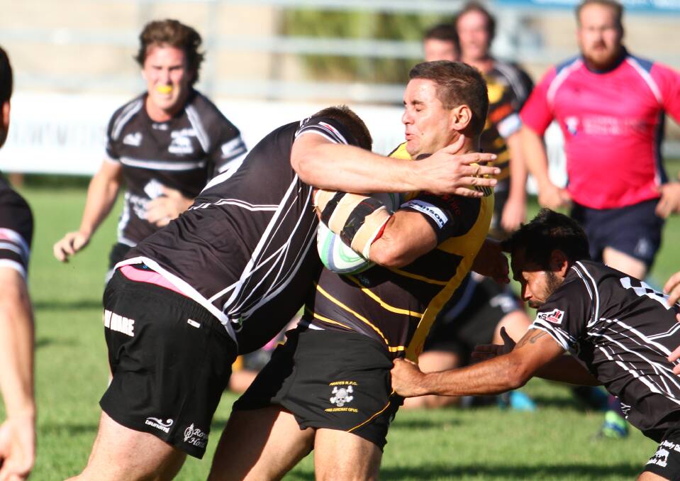 WHACK: Pirates five-eighth Andrew Moodie gets crunched early in the match by Bulls prop Hayden Wiblen. Photo: Mark Bode