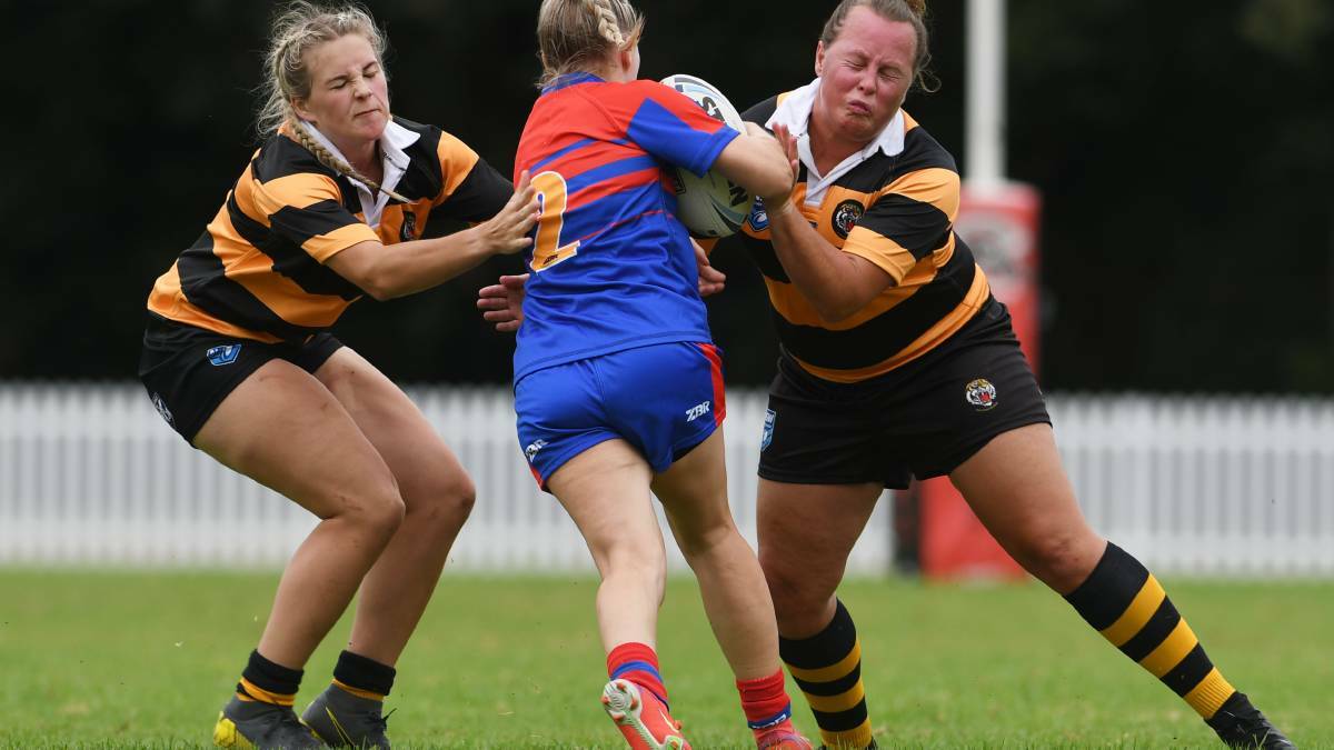 BLOW: The Tigers were hampered after playmaker Amy Barraclough (right) suffered a hamstring injury early in the clash against the Rams. Photo: Gareth Gardner