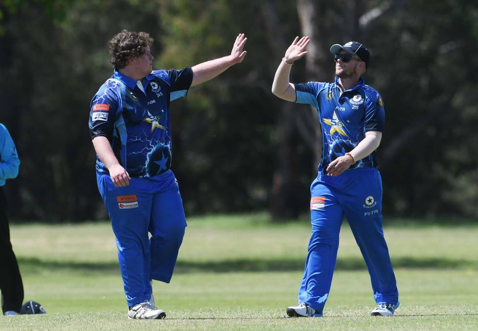 IN A SPIN: Matt Bryant (left) is congratulated by Jaryd Stevens after taking a wicket last Saturday. Photo: Gareth Gardner 