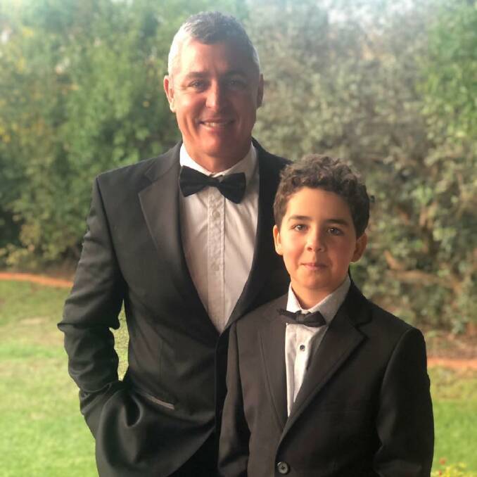 DAPPER: Hennessy with his son, Ollie, 9. Photo: Supplied