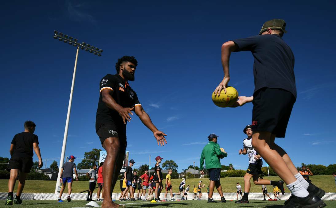 COMMUNITY RELATIONS: The Tigers hold a junior rugby league clinic at Scully Park on Thursday. Photo: Gareth Gardner